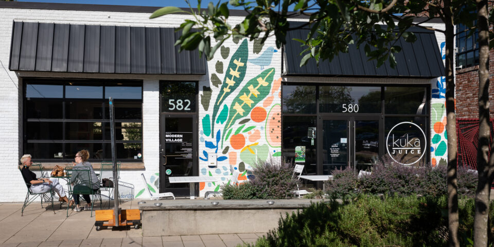 Mural and outdoor seating in The Village of West Greenville
