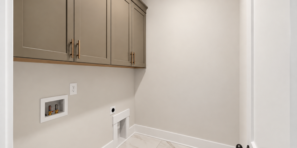 The Kitson laundry room with taupe cabinets